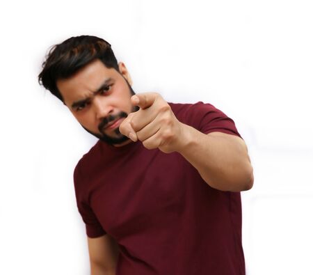 A young attractive Indian angry man pointing his finger towards you.の写真素材
