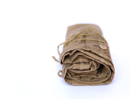 Closeup of folded trousers, clothes on a white backgroundの写真素材