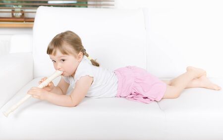 sweet happy little girl with instrumentの写真素材