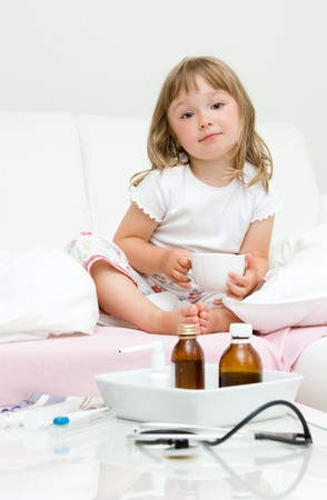 sick litttle girl  on bedの写真素材