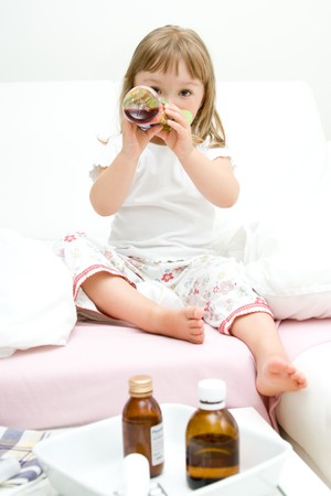 sick litttle girl  on bedの写真素材