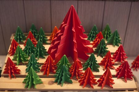 many christmas tree paper cut handmade both green and red one around big red oneの写真素材