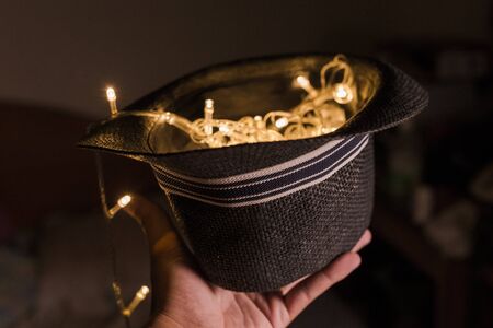hand lift fedora hat with LED light bulb full fill inside itの写真素材