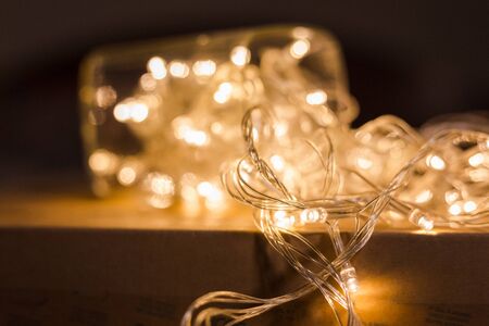 blurred LED light bulb wire with bokeh on paper box