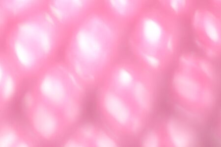 Macro closeup side of soft pink fruit net with light shine on, blurred