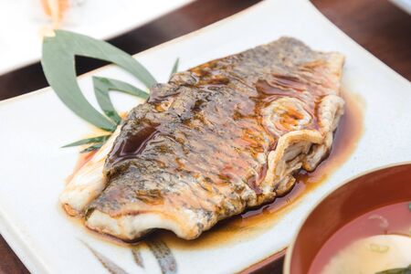 fish slice fried with teriyaki sauce serve on japanese plateの写真素材