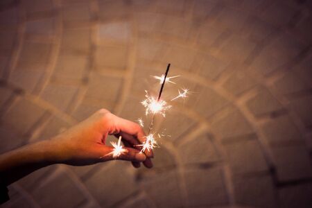 play firesparkler blink in hand burned until half of it at night toningの写真素材