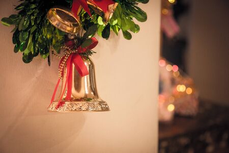 golden bell on christmas eve day in the party hang on the wall with bogeyの写真素材
