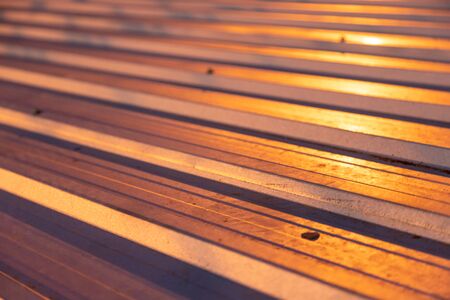 closeup metalic roof pattern with some dirty stain, have yellow light shine on at night time - more darkの写真素材