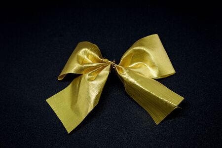 golden ribbon for gift on luxury black bg