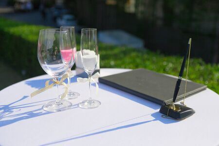 color sand in wine glass cup for let couple in wedding ceremony pour into big one together, it's...