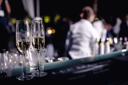 couple glasses of champagne leaving on the bar in the partyの写真素材