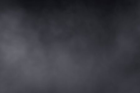 Smoke dry ice move spread all over around in the air, have hard contrast on black backgroundの写真素材