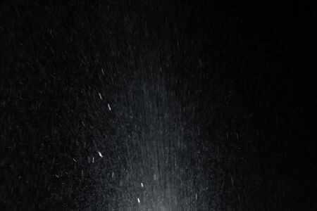 Water splash from the bottom overlay effect on black background.の写真素材