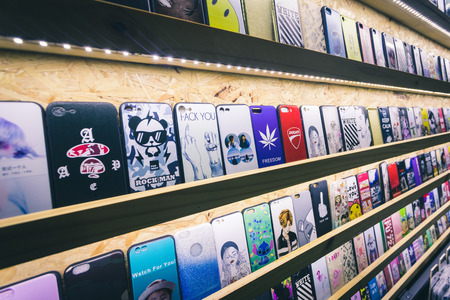 Phuket, Thailand - 10 December 2018 : mobile case with many pattern and design put on shelves in a shop, edit in vintage styleのeditorial素材