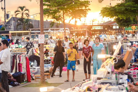 Phuket, Thailand - 9 october 2018 : Thai people walking around street market and show up some Thai text on shop label, got sun shine from sunsetのeditorial素材