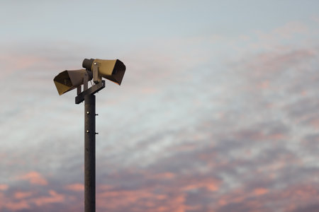 Speaker in the stadium against Twilight sky with a lot of cloud, have gold light of sunset shine on...