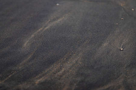 Soft smooth Black sand texture on the beach with pebble around mix with normal sandの写真素材
