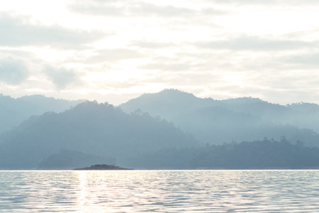 Morning sunshine relect on the river with mountain behindの写真素材