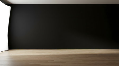 A minimalistic interior scene featuring a black wall and a soft light illuminating one corner. The empty room exudes serenity and modern appeal for creative photography.の素材