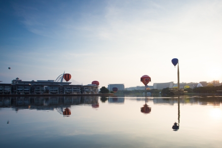 PUTRAJAYA, MALAYSIA - MARCH 30  Colourful and multi shaped hot air balloons floating over foggy sunrise skies at the 5th Putrajaya International Hot Air Balloon Fiesta in Putrajaya, Malaysia on March 30, 2013 のeditorial素材