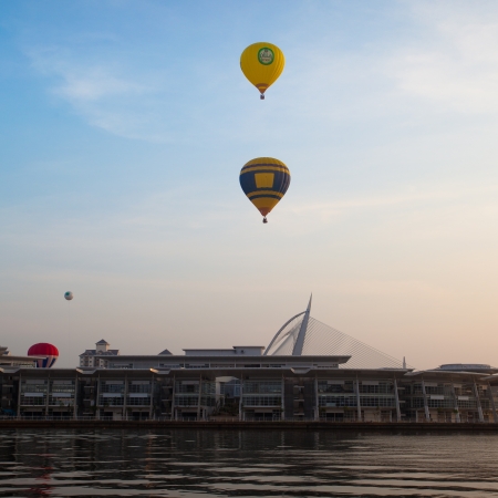 PUTRAJAYA, MALAYSIA - MARCH 30  Colourful and multi shaped hot air balloons floating over foggy sunrise skies at the 5th Putrajaya International Hot Air Balloon Fiesta in Putrajaya, Malaysia on March 30, 2013 のeditorial素材