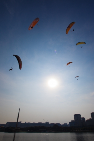 PUTRAJAYA, MALAYSIA - MARCH 30    A Paragliding enthusiasts flying in blue sky at the 5th Putrajaya International Hot Air Balloon Fiesta in Putrajaya, Malaysia on March 30, 2013  のeditorial素材