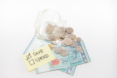Money saving concept- Saving vs Spendingの写真素材