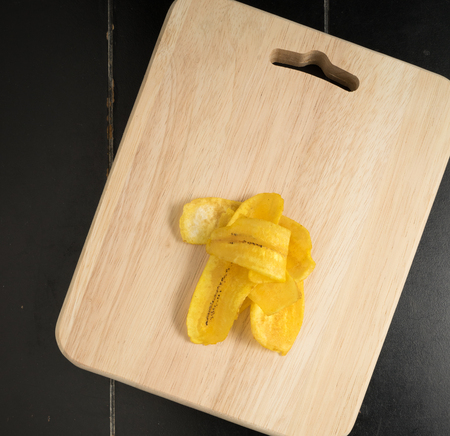 Fried banana chips on a wooden backgroundの写真素材