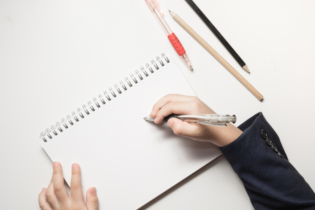 Hand writing on notebook page, view from above - COPY SPACEの写真素材