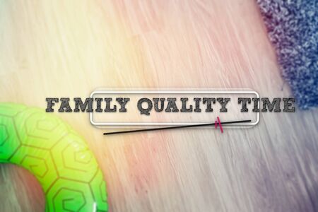 Life buoy over wooden deck with the phrase FAMILY QUALITY TIMEの写真素材