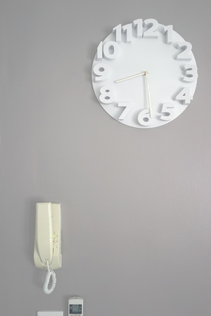 Wall clock isolated on grey backgroundの写真素材