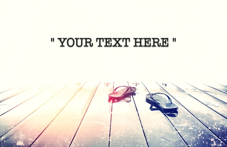 Flip flops on wooden deck with summer background. Copy spaceの写真素材