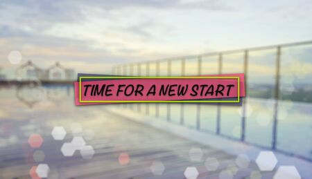 Word TIME FOR A NEW START on blurred background of sunrise over an infinity swimming poolの写真素材