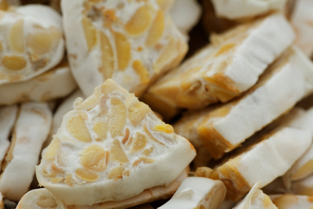 Sliced fresh raw tempeh. Close up showing texture of tempeh. Tempeh is made from soya bean and popular in some part of Asia.の写真素材