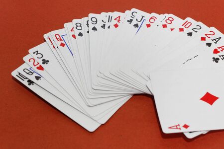 Playing card games on red background