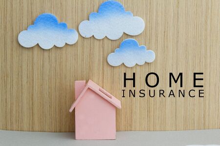 Toy house and toy cloud with words Home Insurance. Concept of insurance, prevention,protection,investment and financial.の写真素材