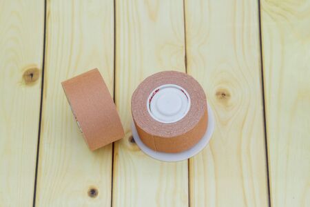 Surgical or medical tape on wooden backgroundの写真素材