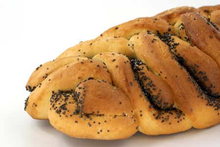 home-made bun with poppy-seed against white backgroundの写真素材