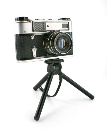 old-fashioned photographic camera on mini-tripod against white backgroundの写真素材