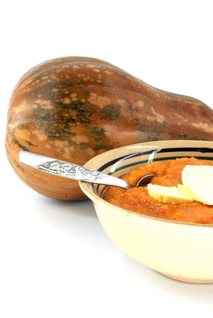 cooked pumpkin in ceramic bowl with whole pumpkinの写真素材