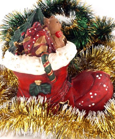 Christmas ceramic toy as shoe with bright  tinsel の写真素材
