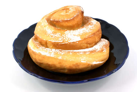 baked bun in plate against white backgroundの写真素材