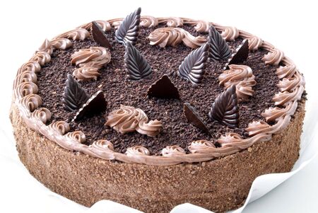 sponge cake with chocolate leaf against white backgroundの写真素材