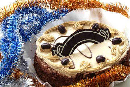 sponge cake with chocolate plate against tinselの写真素材