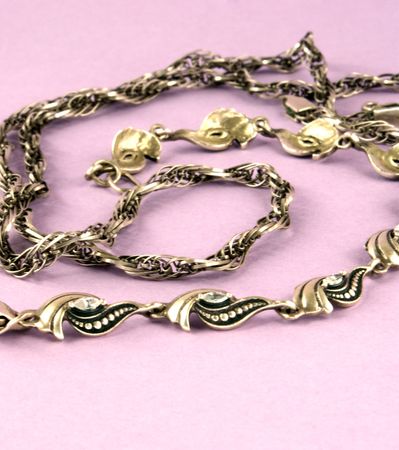 silver chain and bangle against violet backgroundの写真素材
