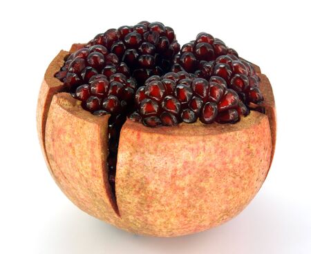 pomegranate cut into sections against white backgroundの写真素材