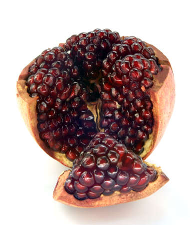 pomegranate cut into sections against white backgroundの写真素材