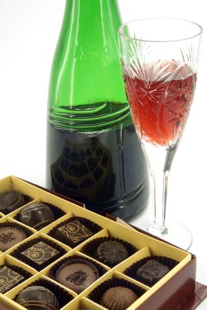 assorted chocolates in box with bottle wine and stemwareの写真素材