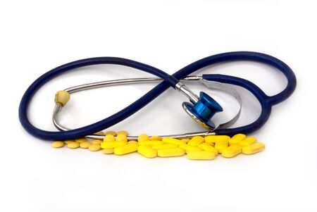 stethoscope with pill against white backgroundの写真素材